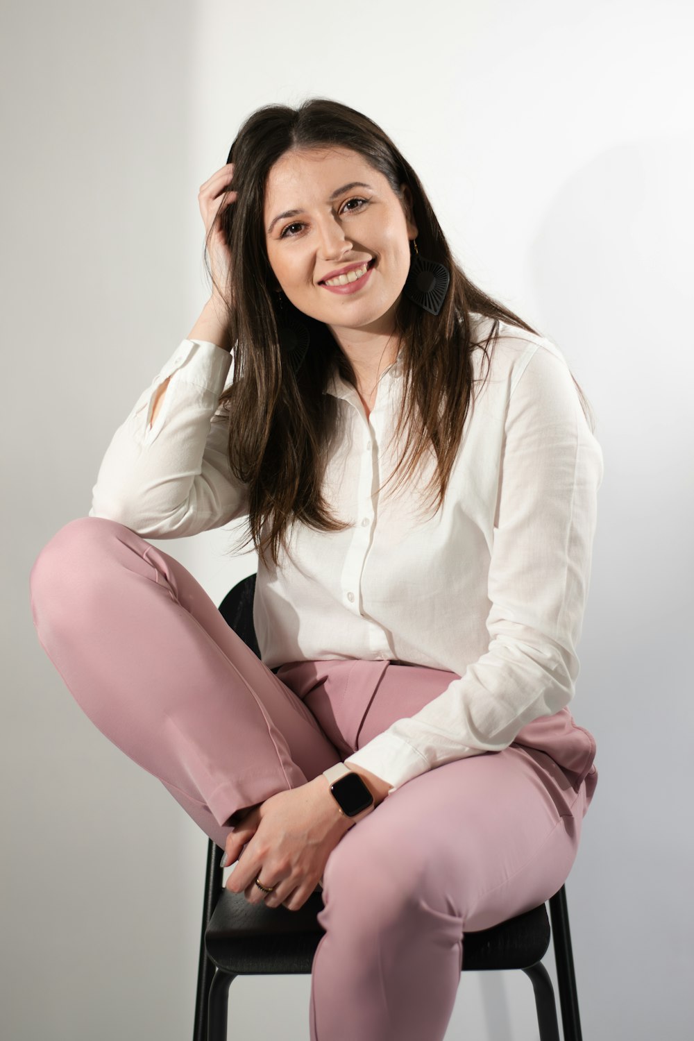 a woman sitting on a chair posing for a picture