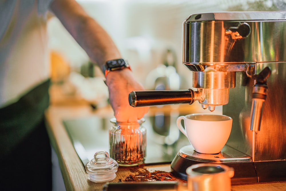 a person is pouring a cup of coffee