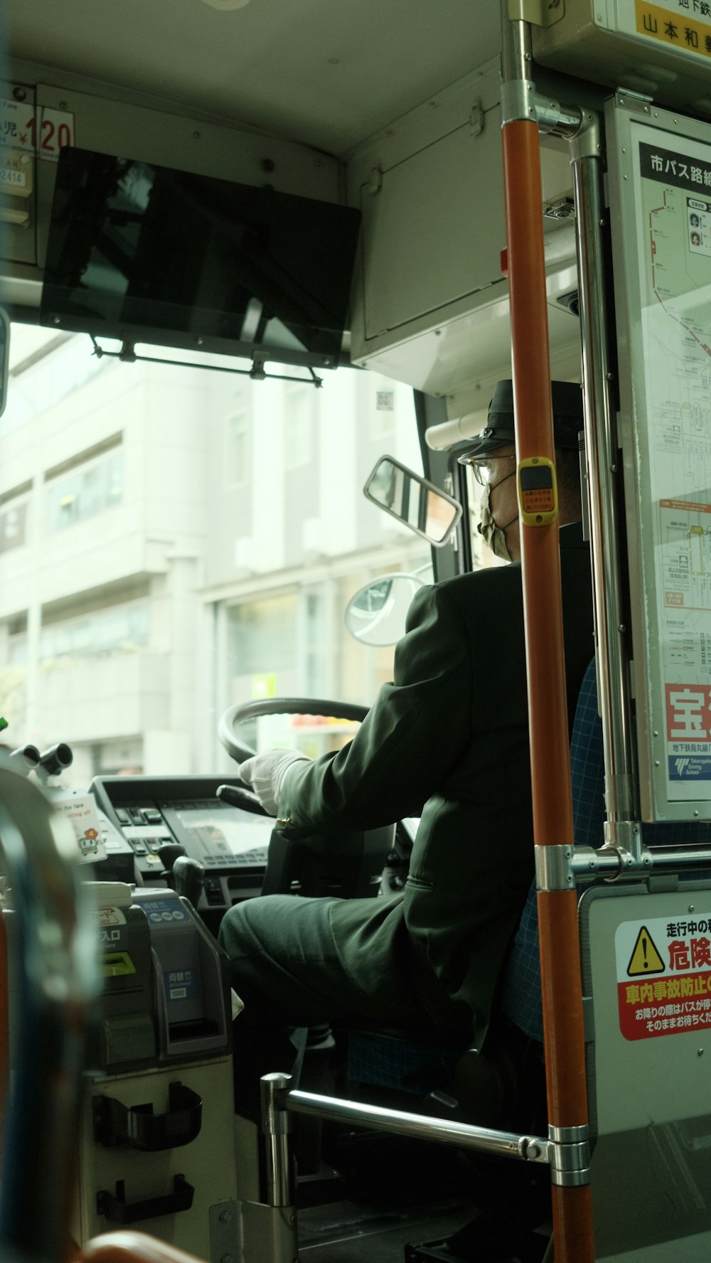 a man sitting in the driver's seat of a bus