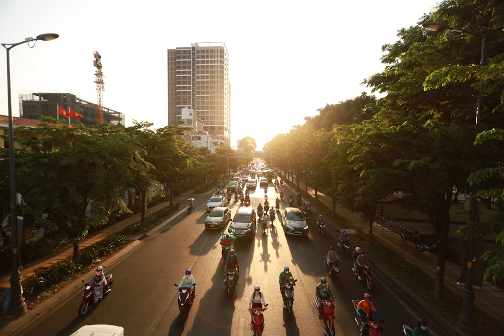 a group of people riding motorcycles down a street