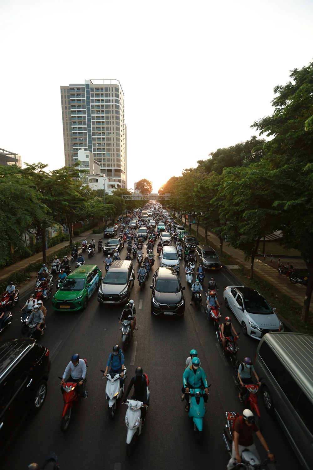 a group of people riding motorcycles down a street