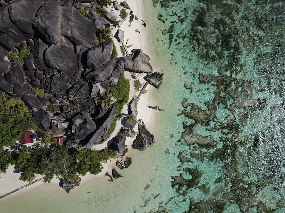 an aerial view of a beach with a hut on it