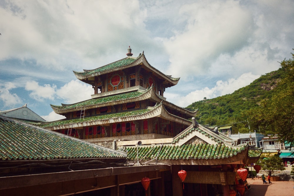 a tall building with a green roof and a red fire hydrant