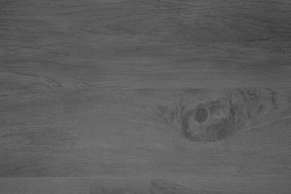 a black and white photo of a wood floor