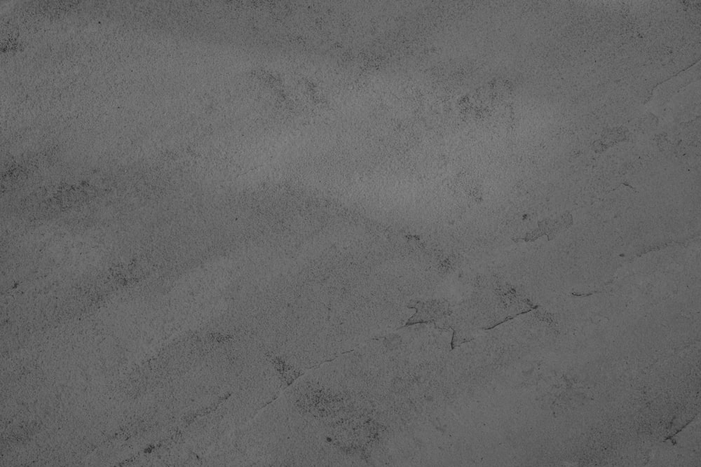 a black and white photo of sand and water