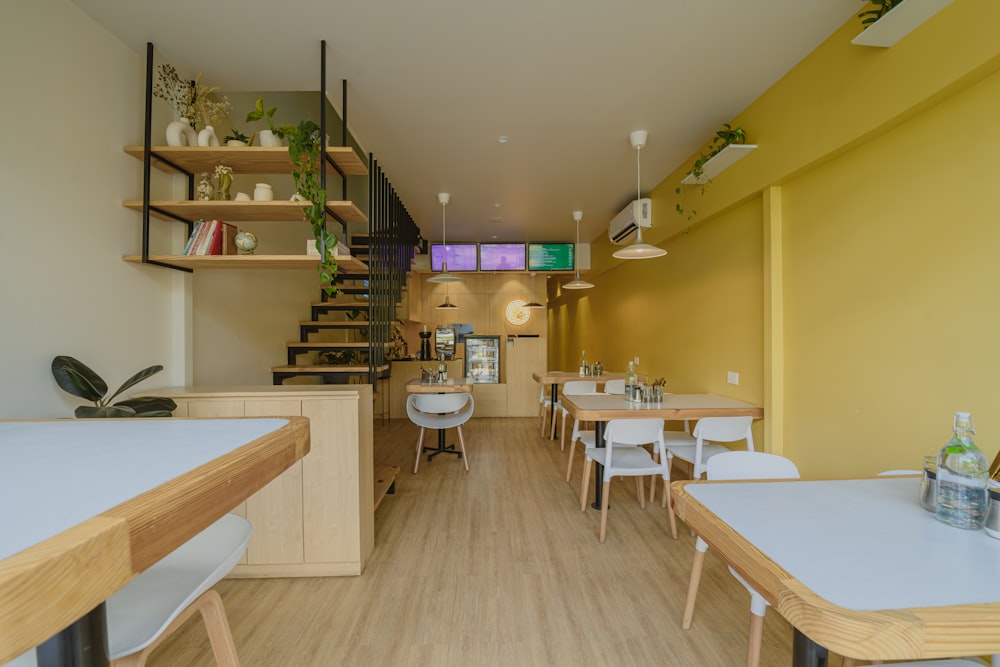 a restaurant with yellow walls and wooden tables