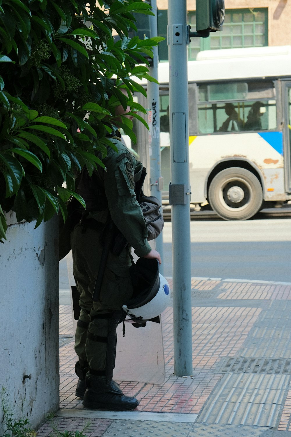 a man in a military uniform leaning against a wall