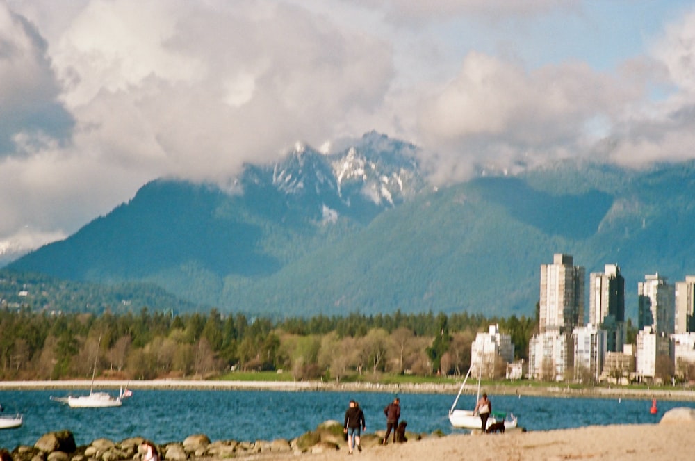 a group of people standing on top of a sandy beach