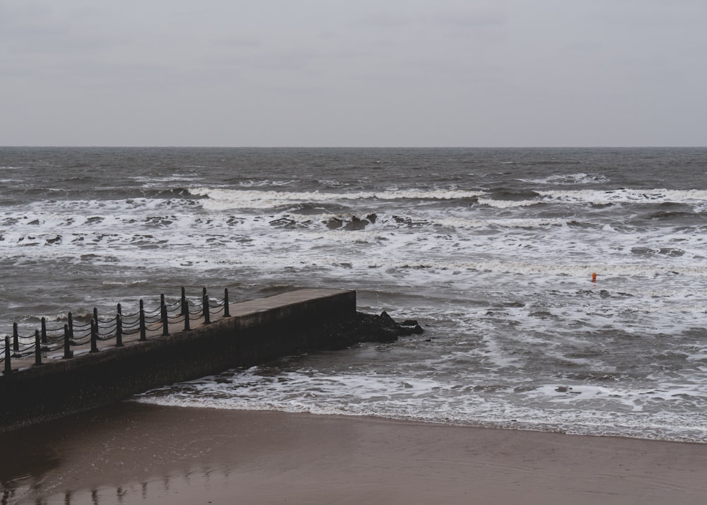 a person walking on a beach next to the ocean