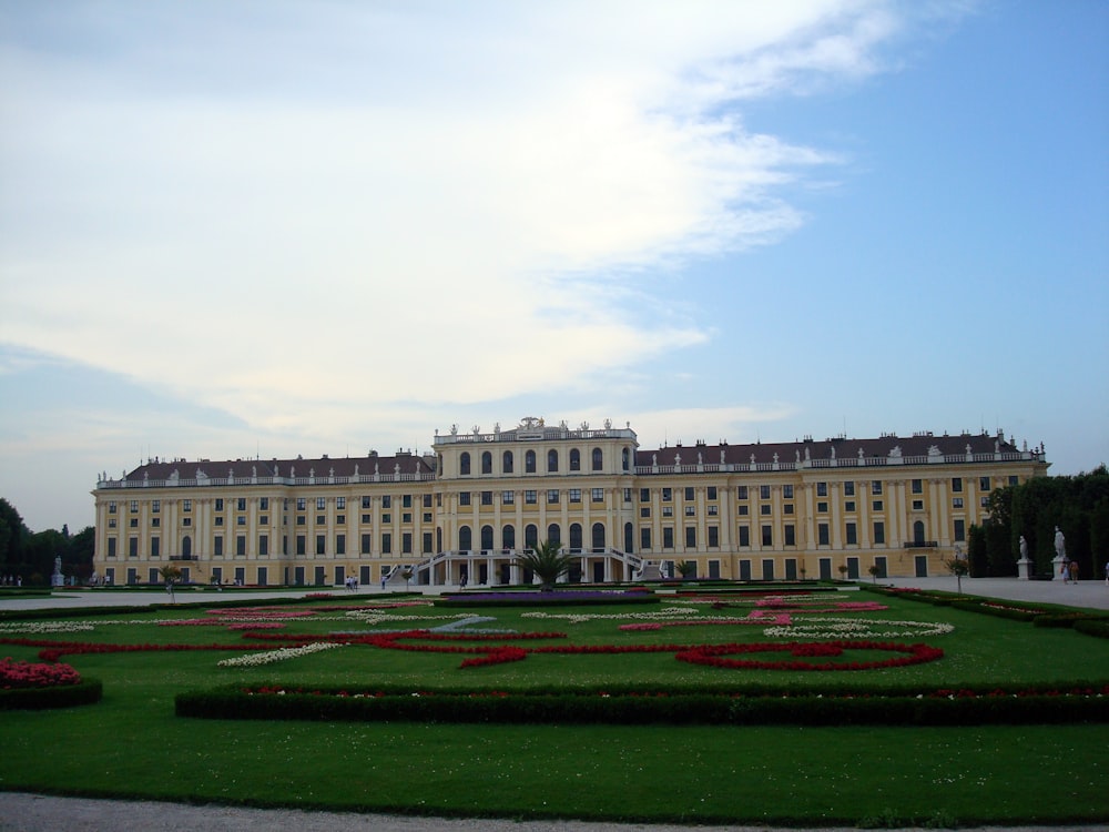 a large building with a garden in front of it