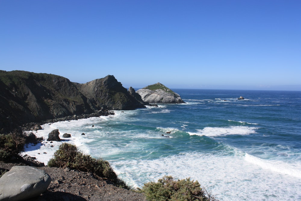 a view of the ocean from the top of a hill