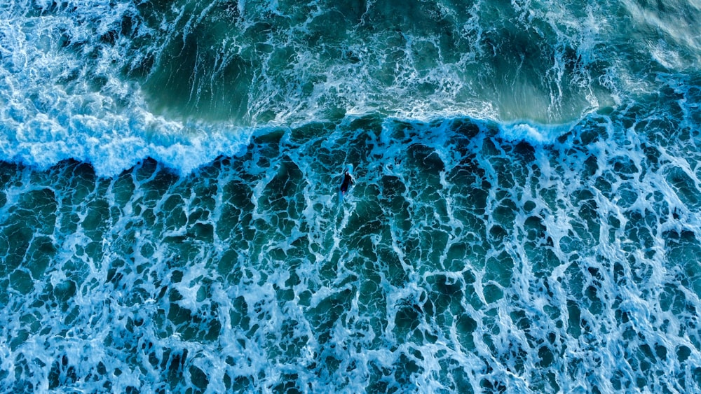 an aerial view of the ocean waves
