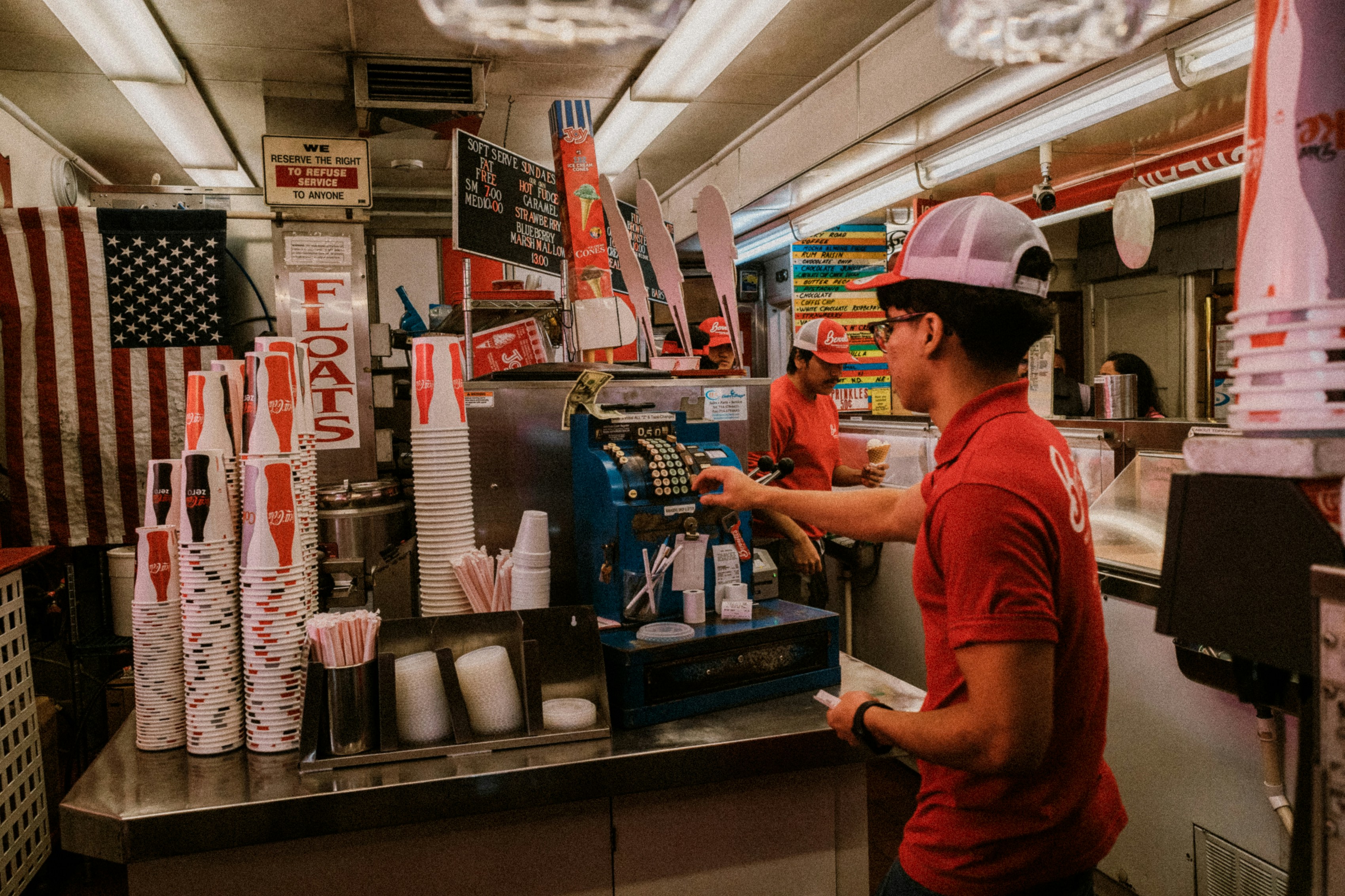 a man standing at a counter in a fast food restaurant
