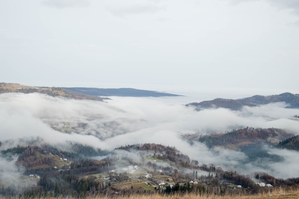 a view of a valley covered in low lying clouds