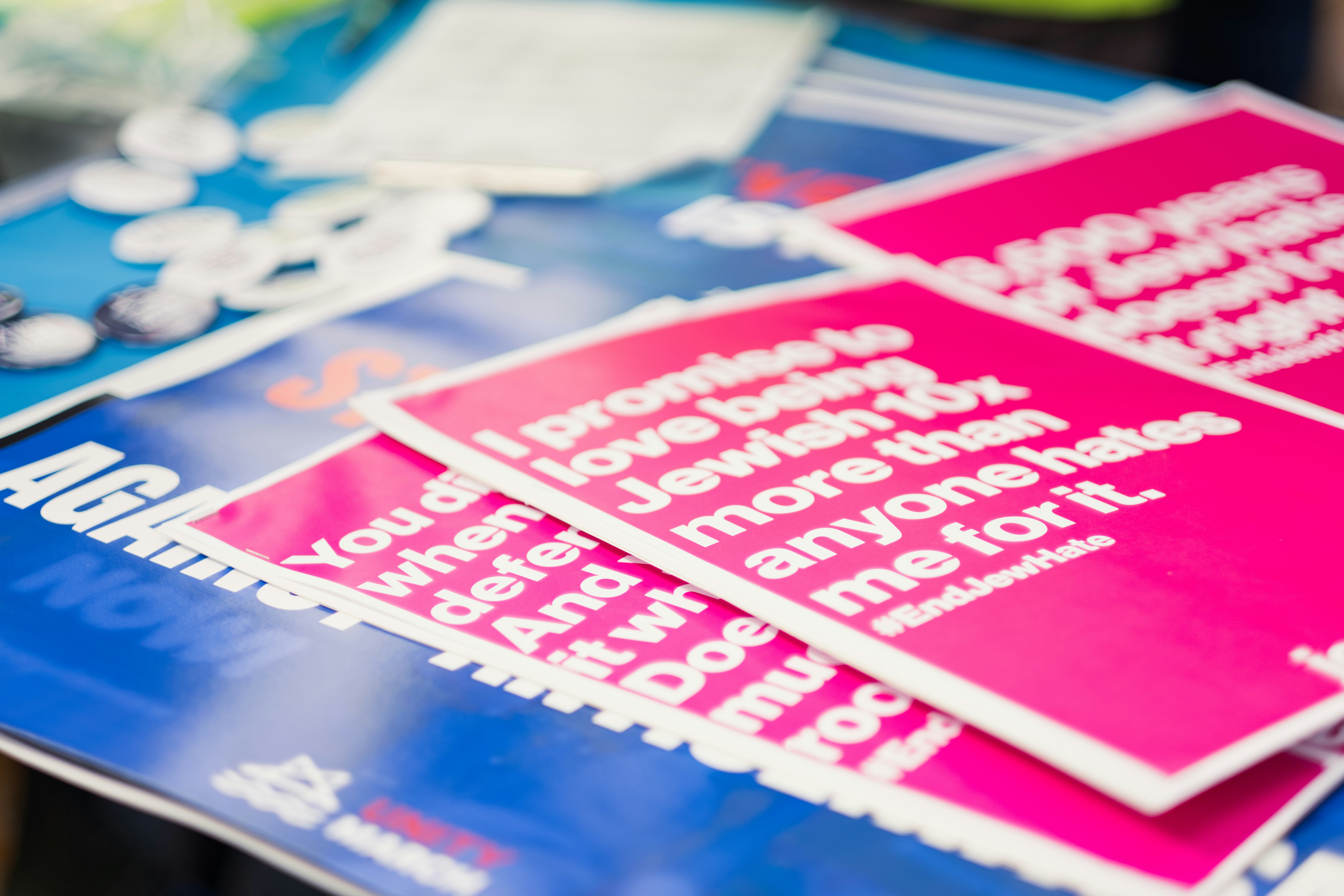 a pile of pink and blue stickers sitting on top of a table