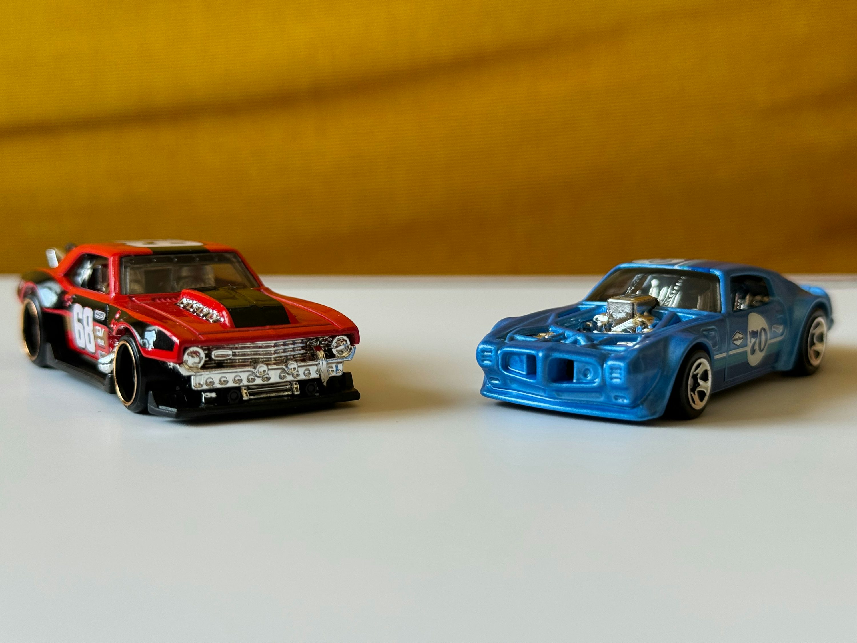 a couple of toy cars sitting on top of a table