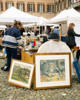 a group of people standing around a table with pictures on it