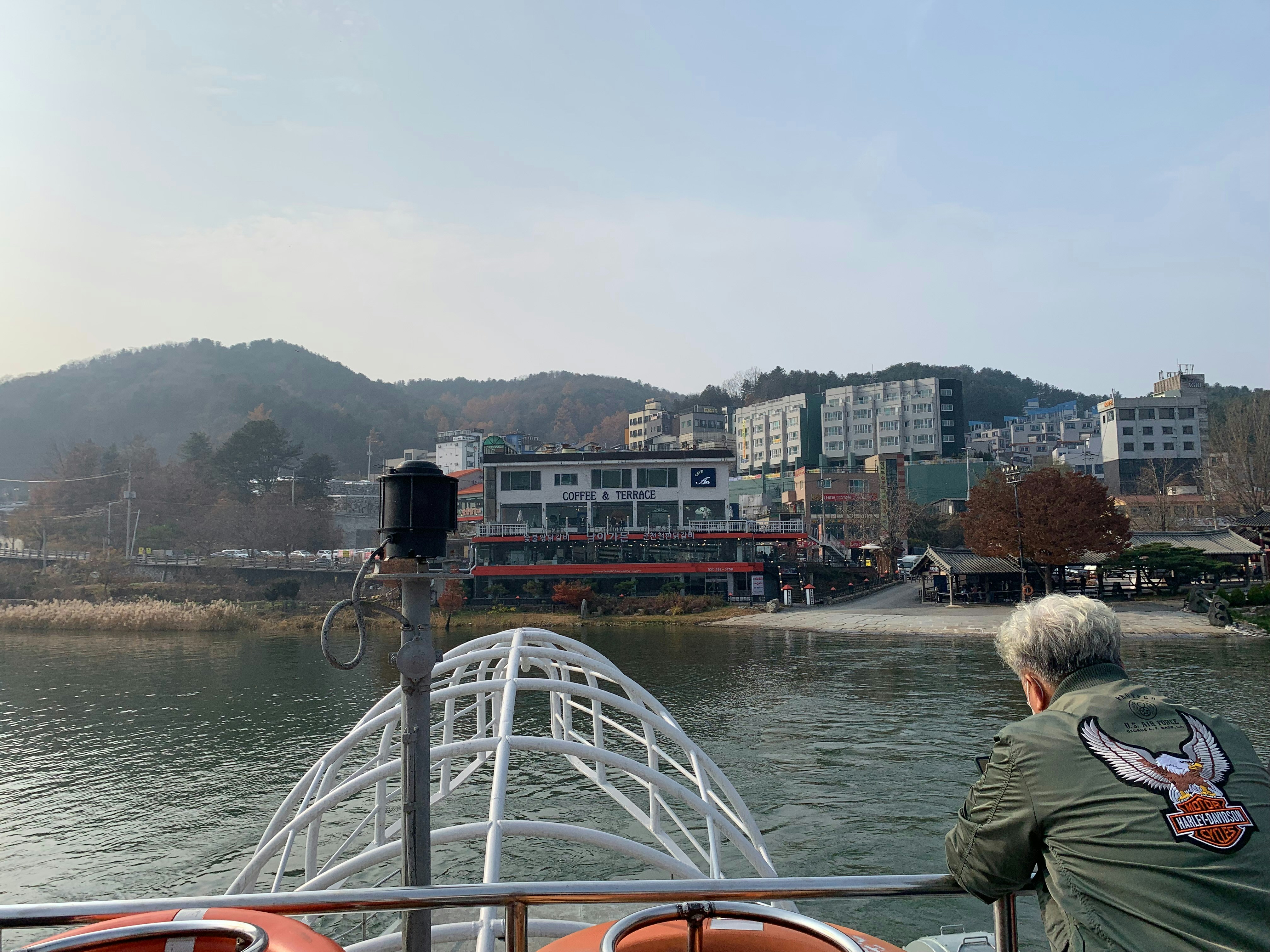 a man sitting on a boat looking out over the water