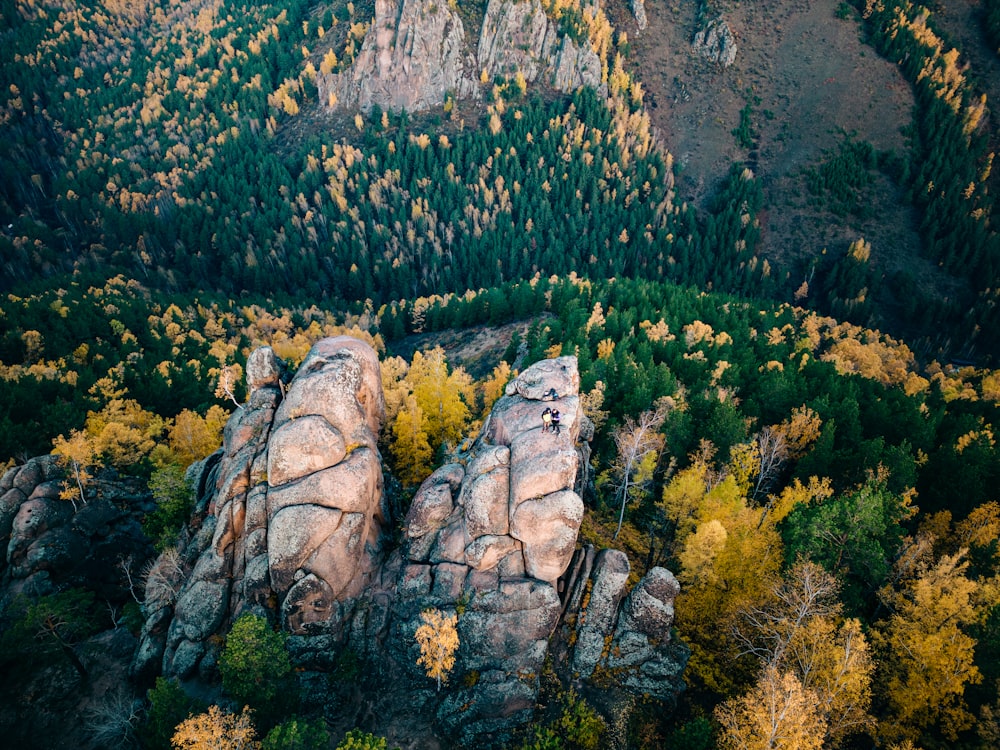 a person standing on top of a large rock