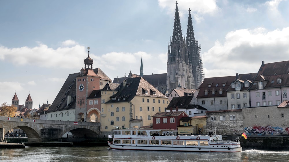 a boat traveling down a river next to tall buildings