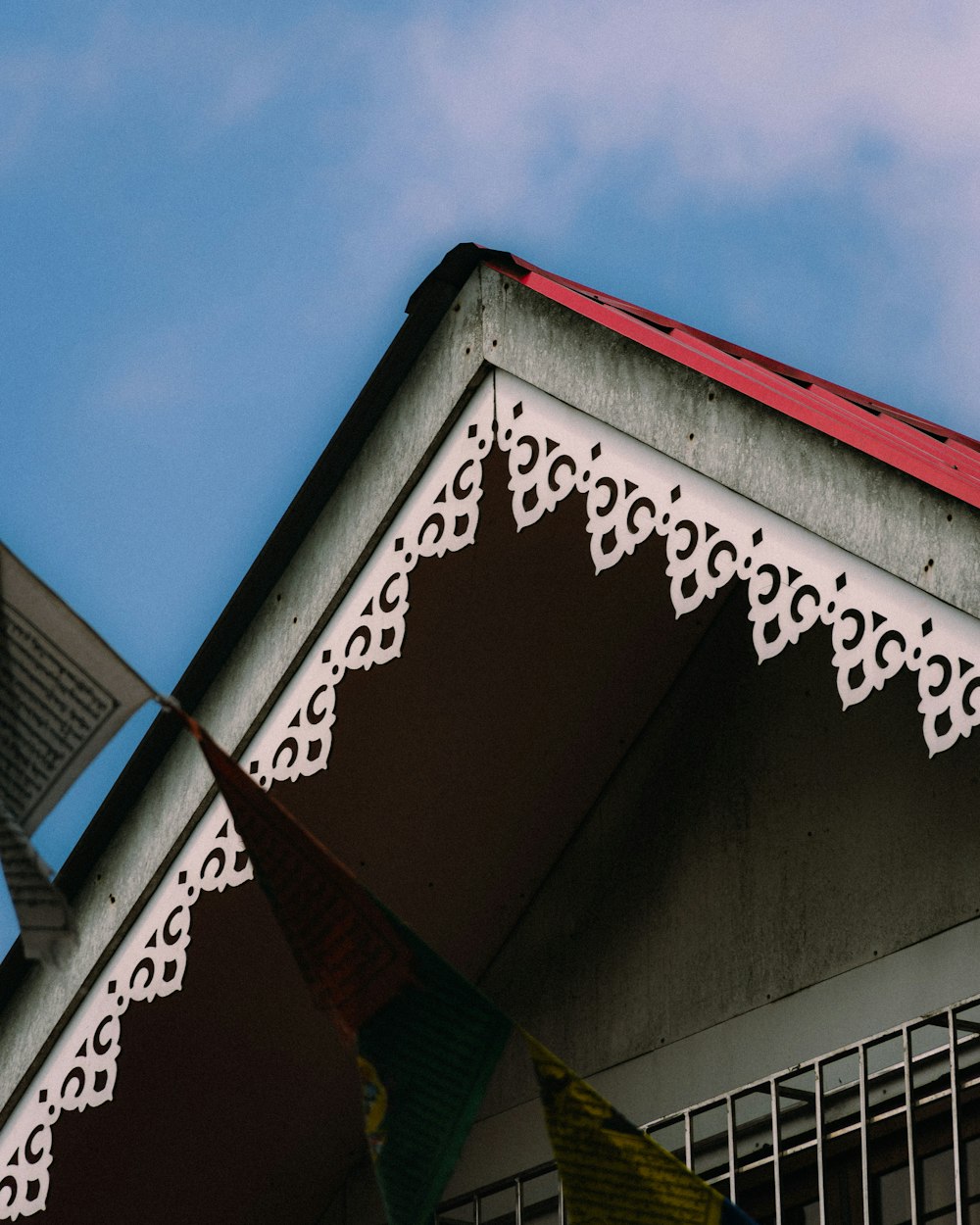 a building with a red roof and white trim