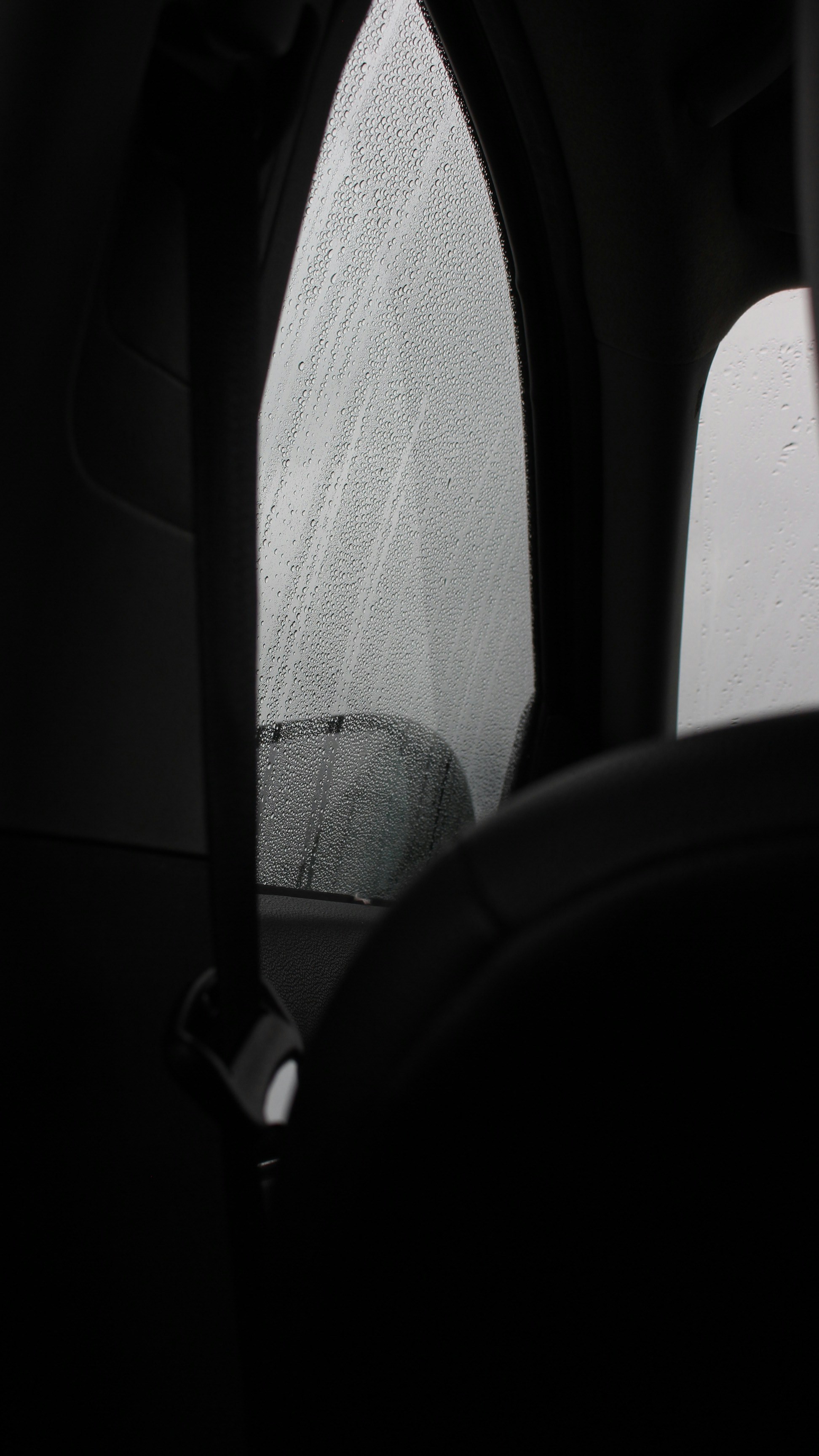 a car's side view mirror with rain drops on it