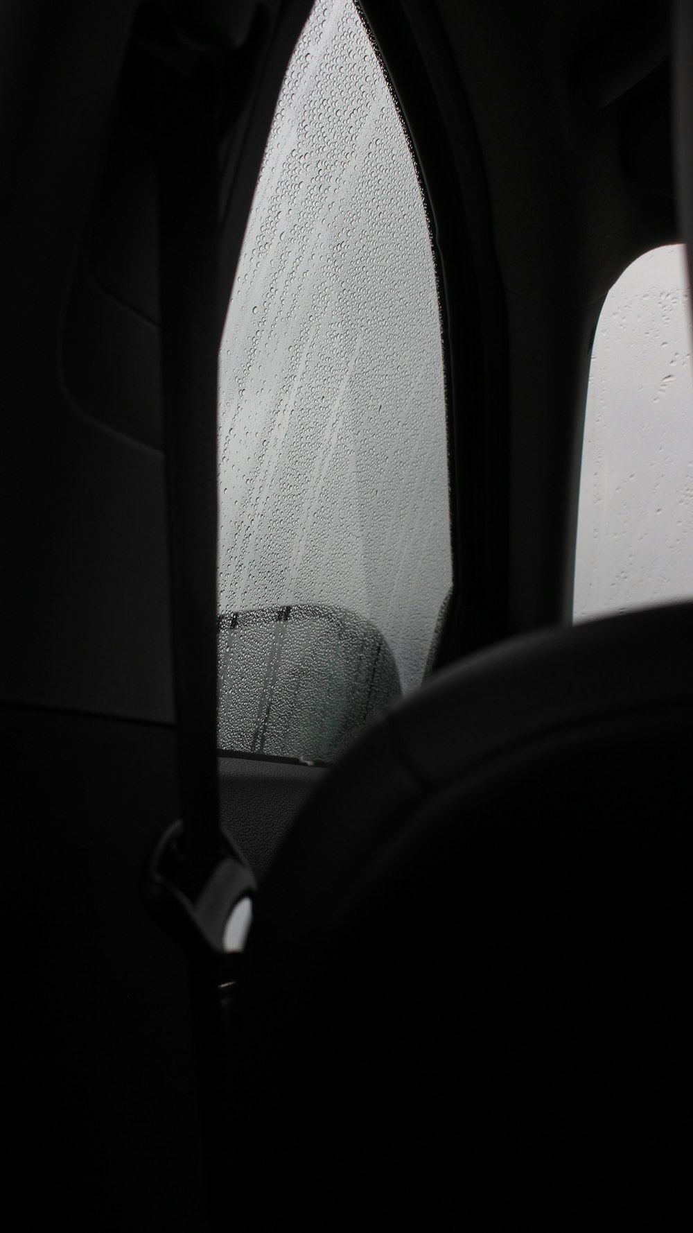 a car's side view mirror with rain drops on it