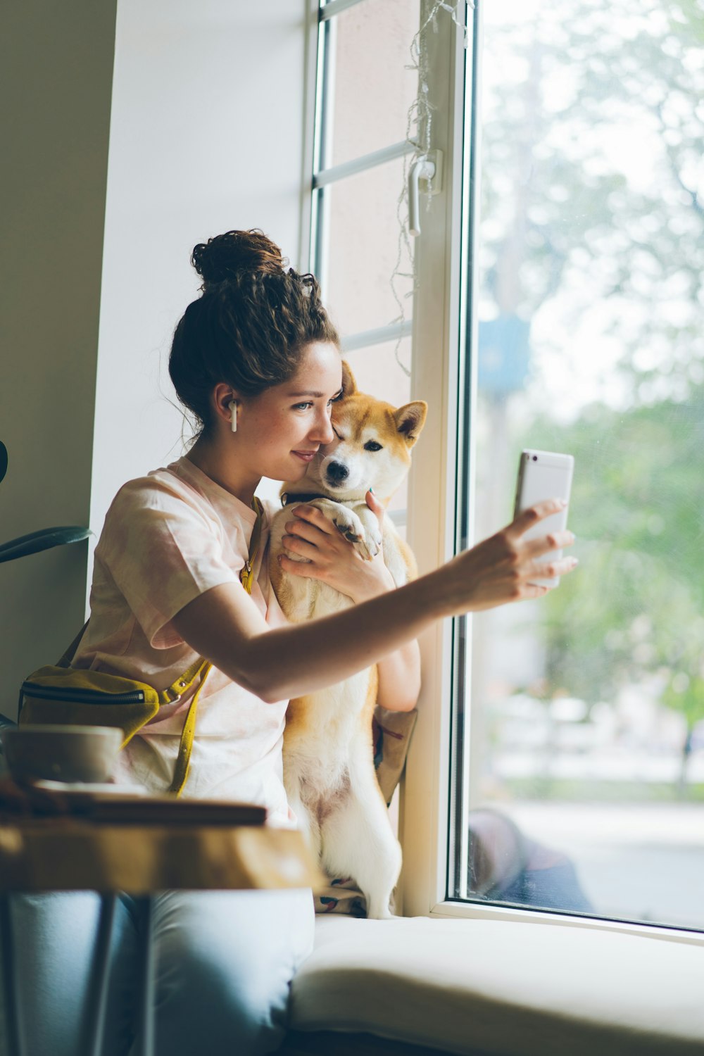a woman taking a picture of herself with her dog
