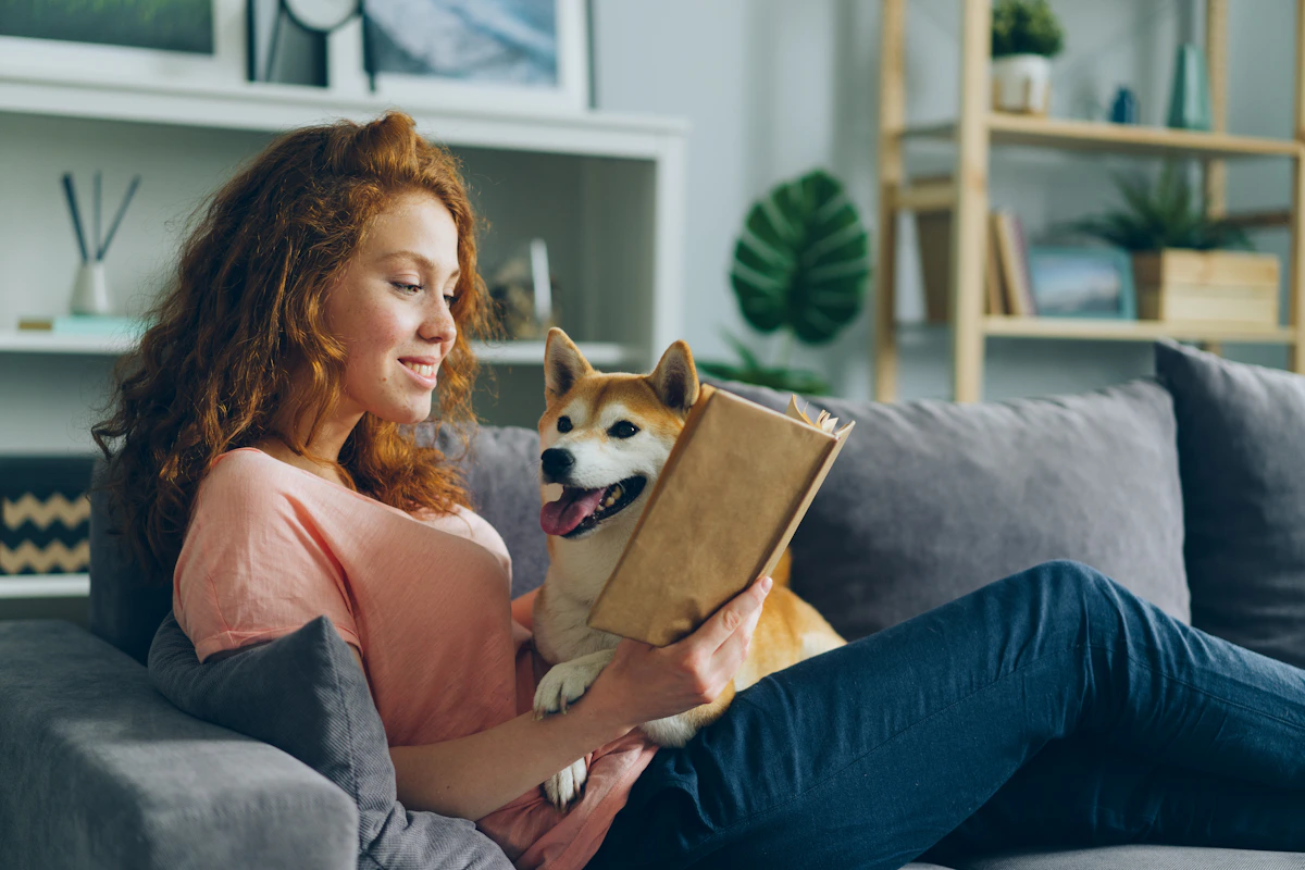 Pet parent relaxing with dog at home