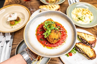 a person holding a plate with food on it