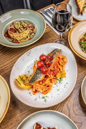 a wooden table topped with plates of food