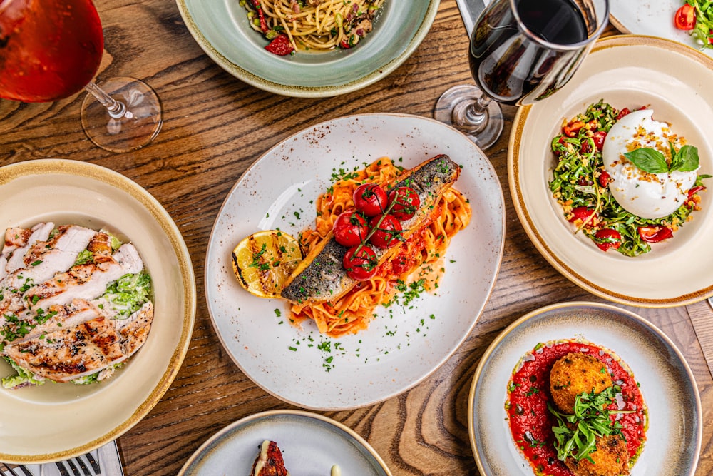 a table topped with lots of plates of food