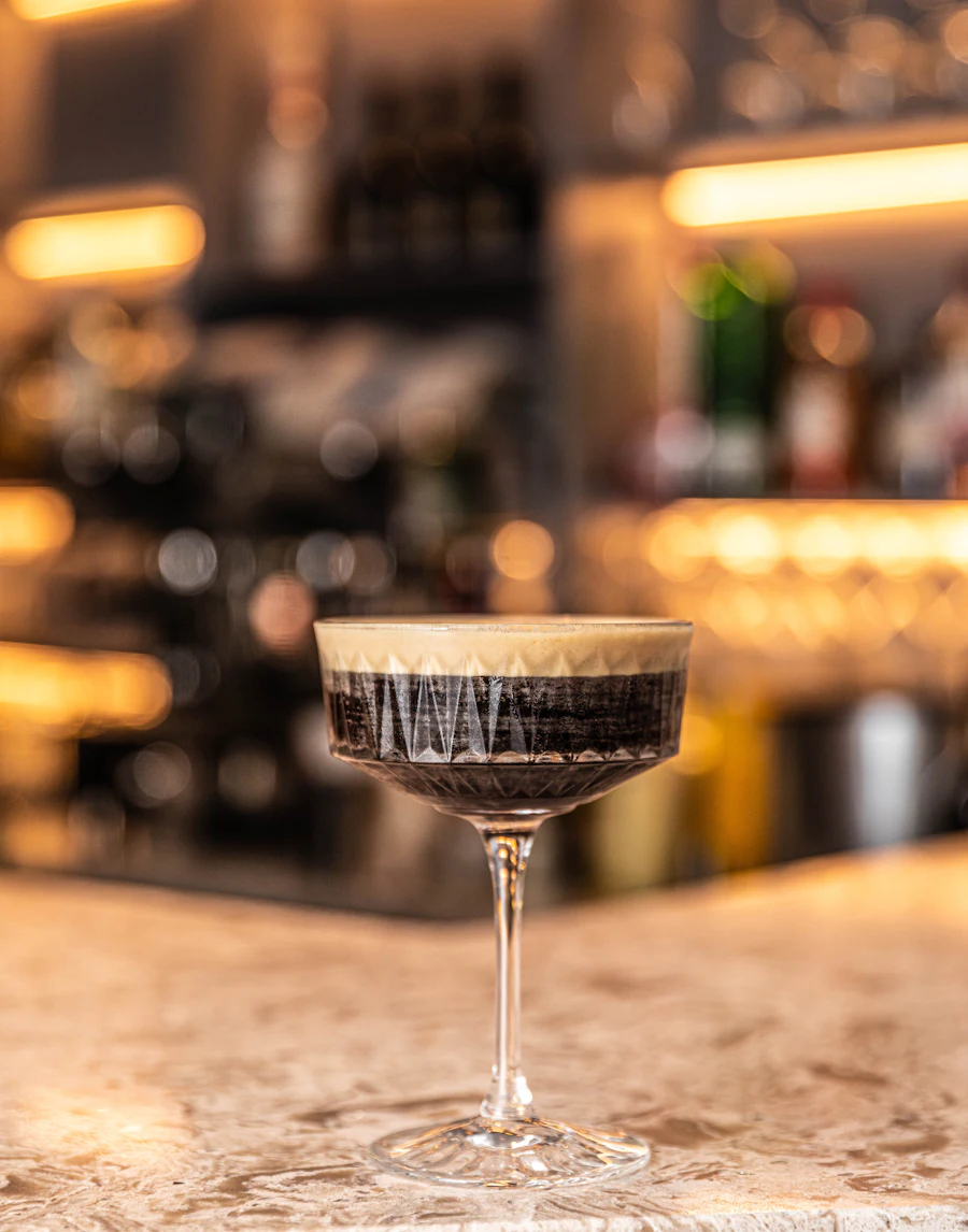 A finished cocktail resting on the bar