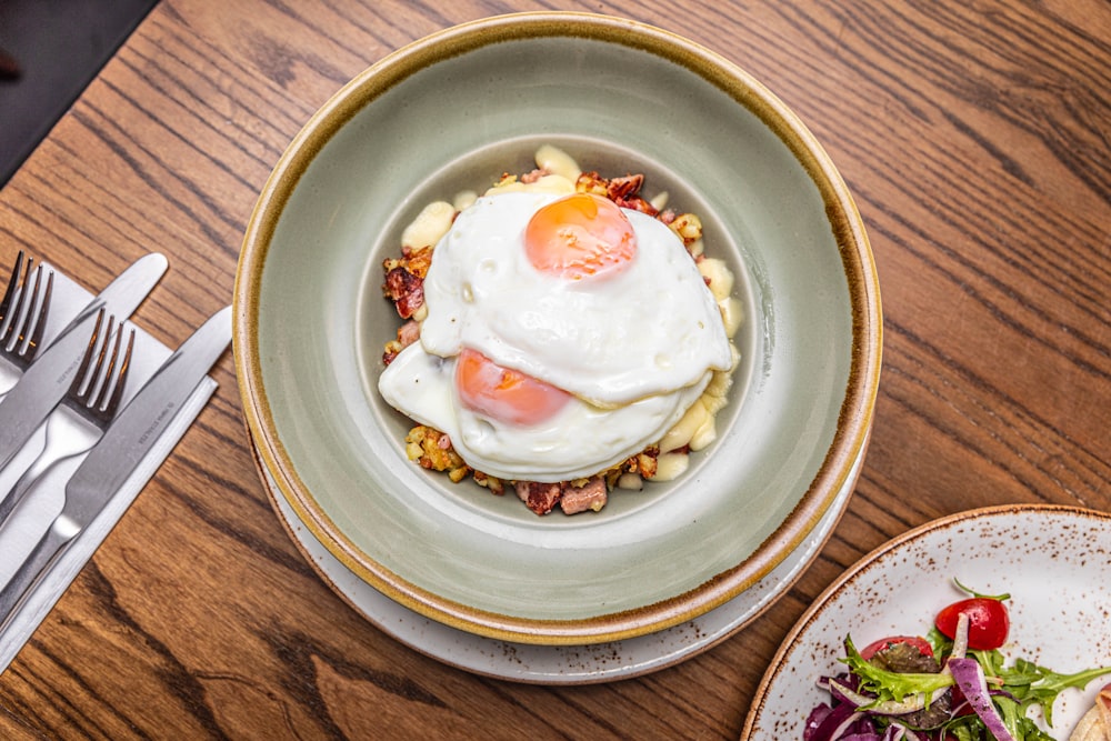 a bowl of food on a wooden table