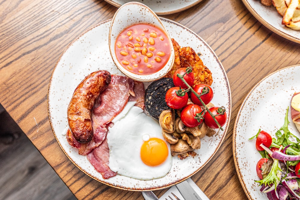 a wooden table topped with plates of food