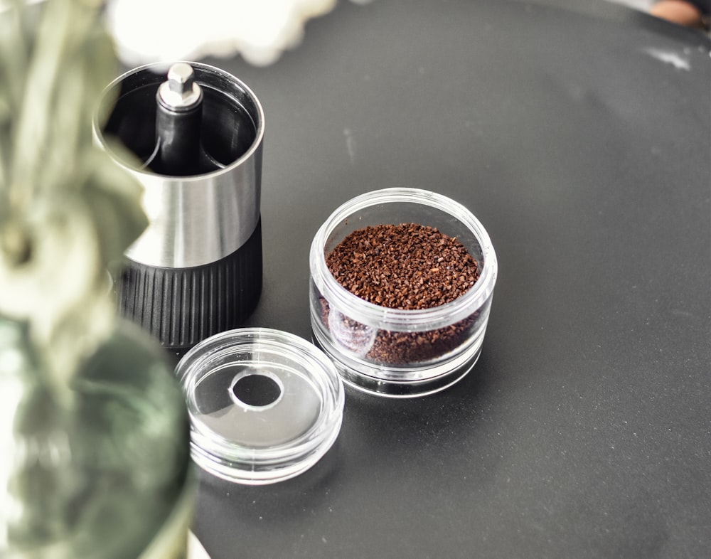 a coffee grinder sitting on top of a black table