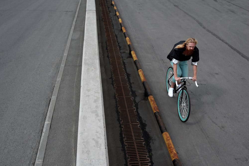 a woman riding a bike down a street