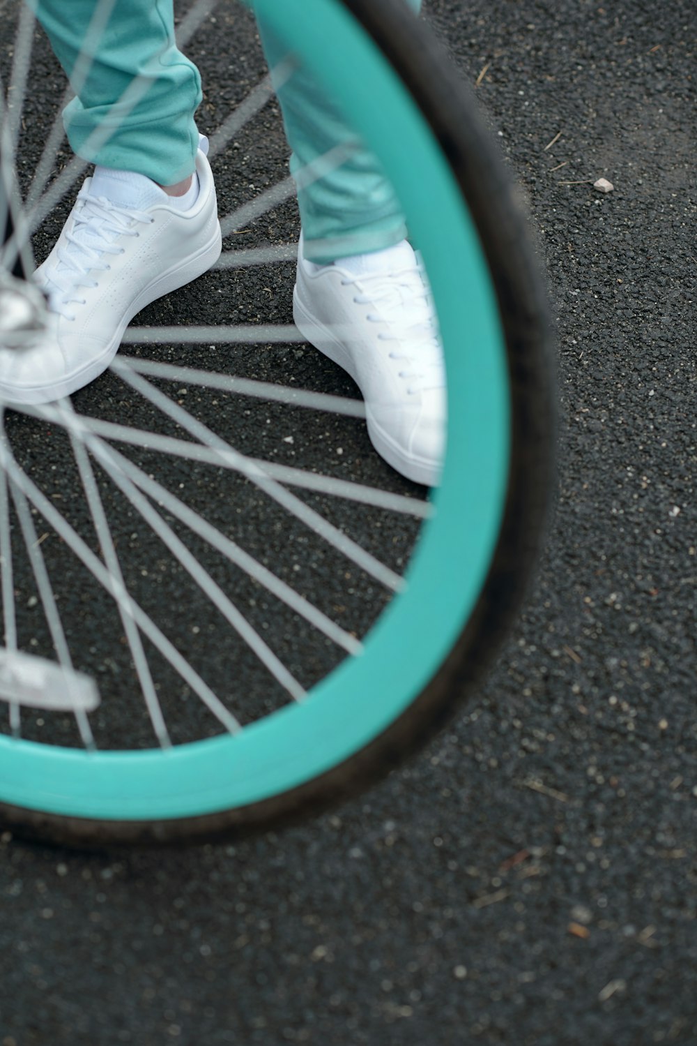 a close up of a person's feet on a bicycle wheel
