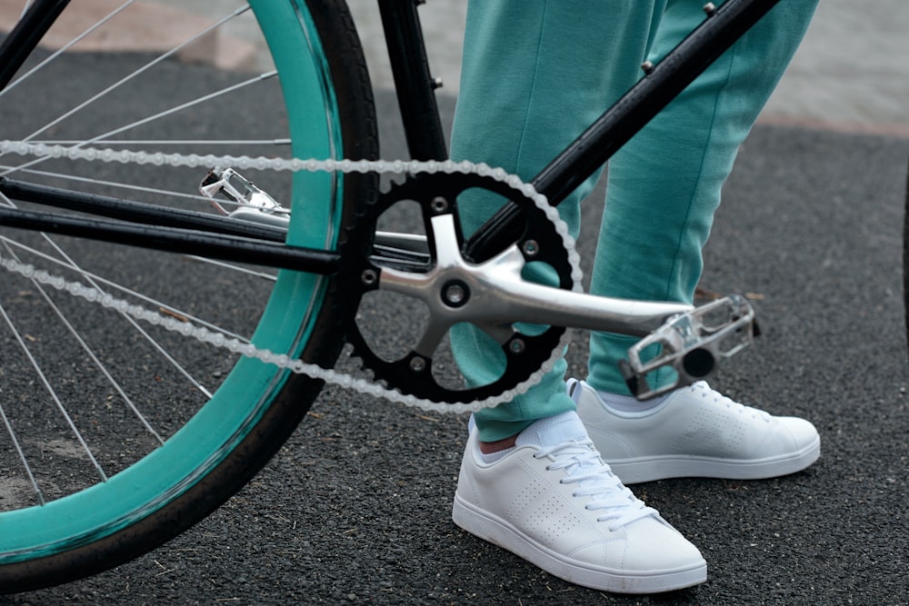 a close up of a person standing next to a bike