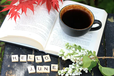 a cup of coffee and a book on a table