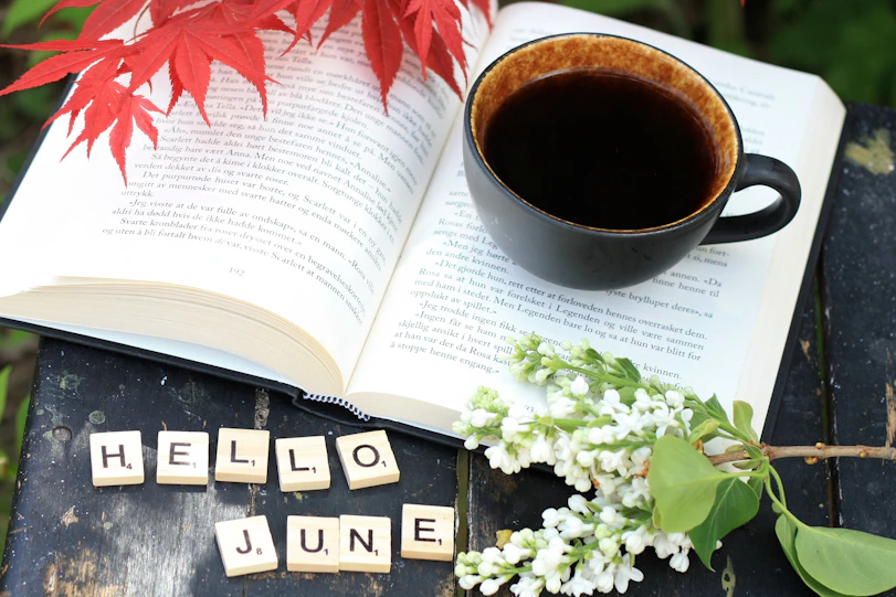 a cup of coffee and a book on a table
