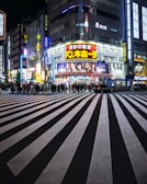 a city street at night with a lot of people