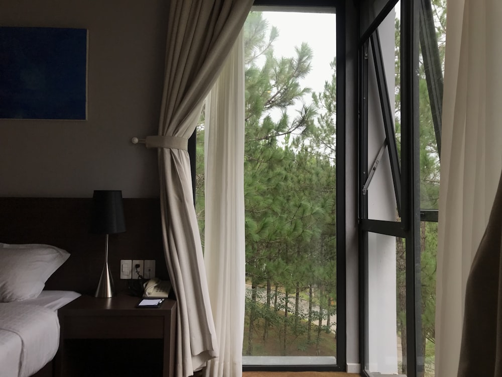 a bedroom with a sliding glass door leading to a balcony