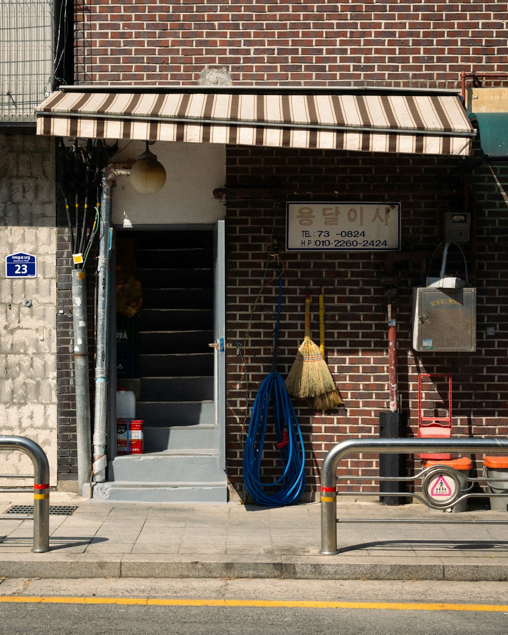 a brick building with a door and a broom