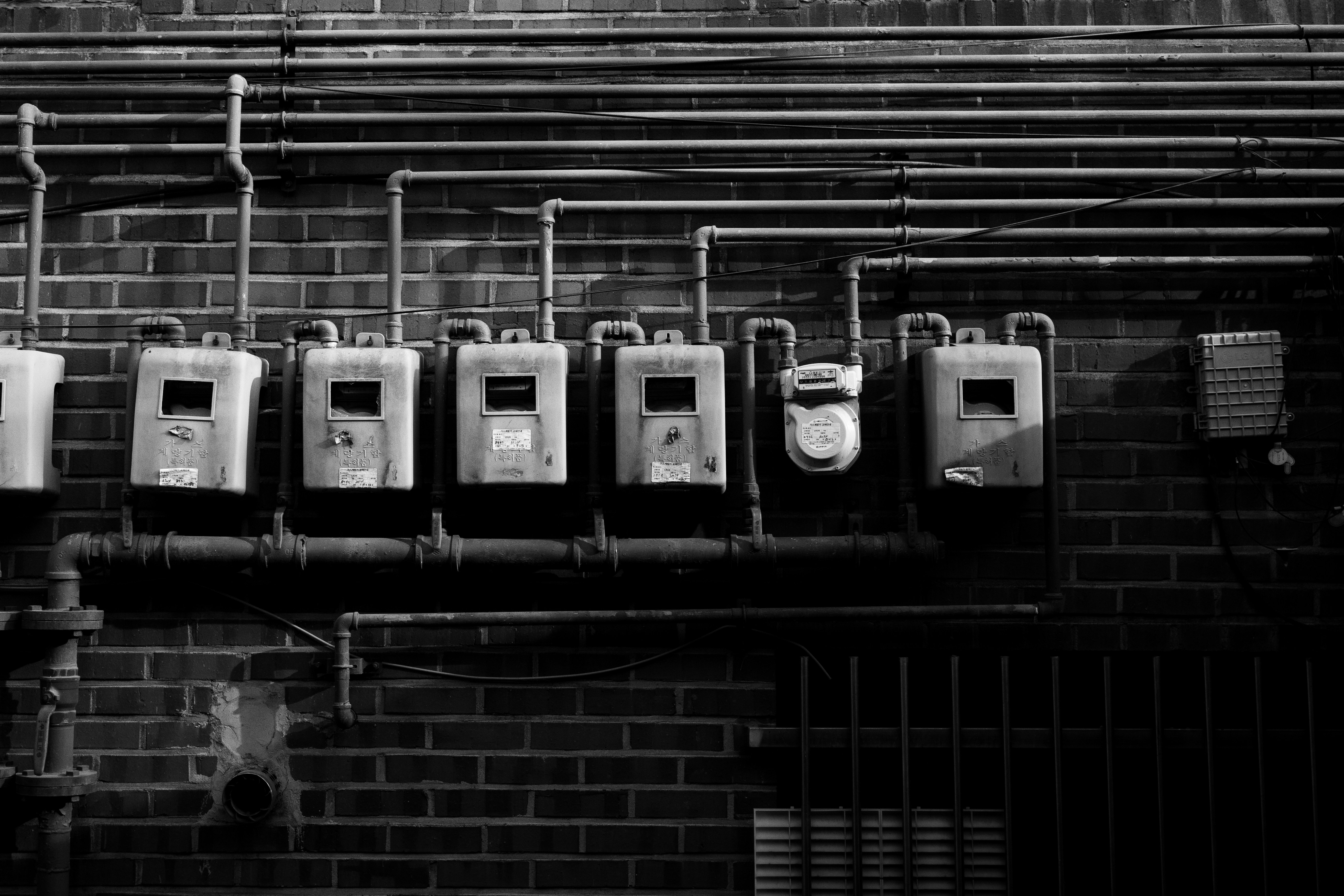 a black and white photo of a row of parking meters