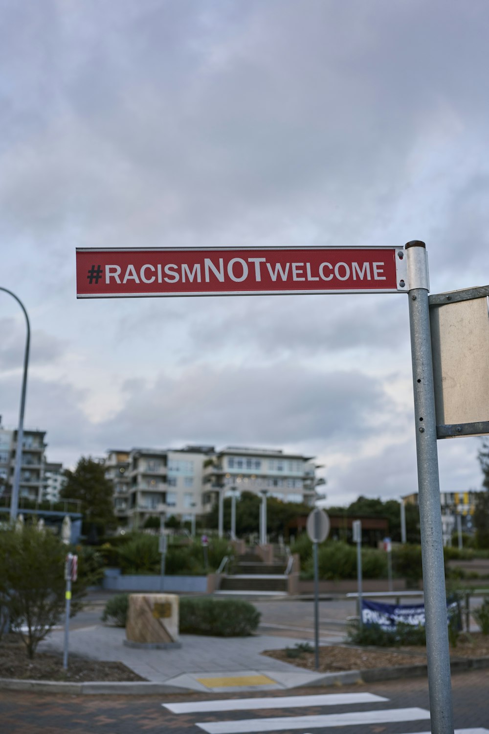 a red and white street sign sitting on the side of a road