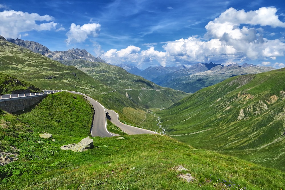 a scenic view of a road winding through a valley