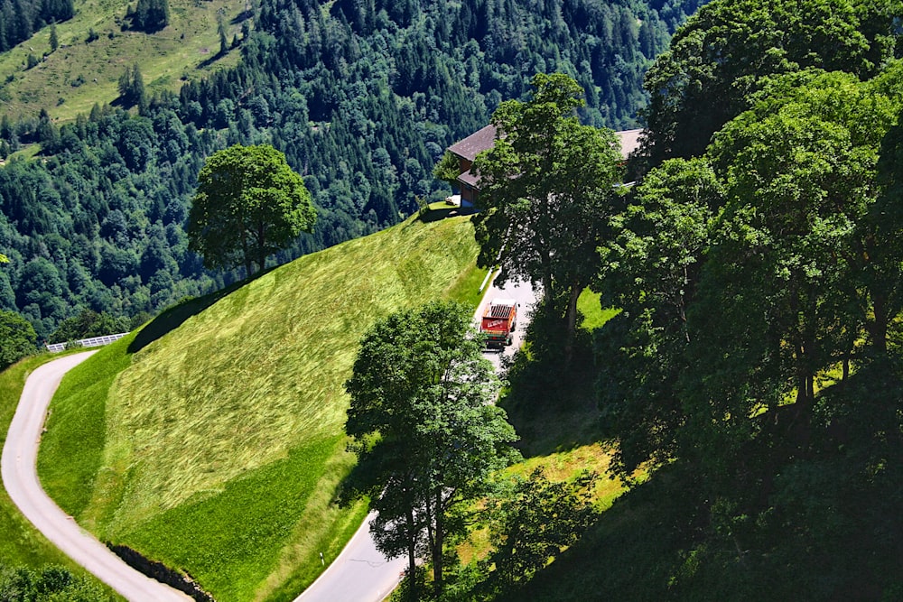 a road winding through a lush green hillside