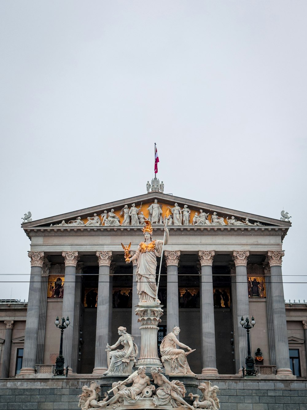 a statue in front of a building with columns