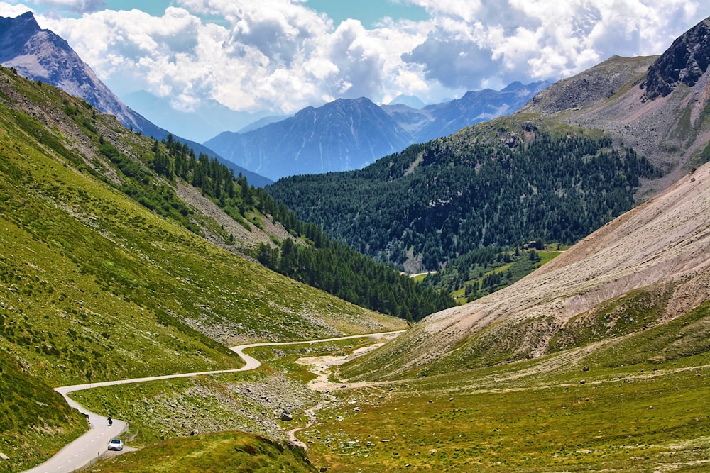 a scenic view of a winding road in the mountains